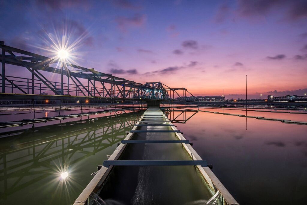 Industrial bridge and walkway reflected at sunset